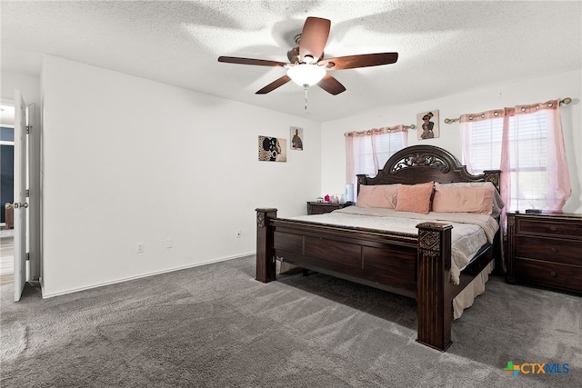 bedroom featuring a textured ceiling, dark colored carpet, and ceiling fan