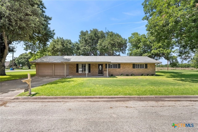 ranch-style house with a porch, a garage, and a front lawn