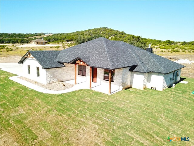 back of house with a patio and a yard