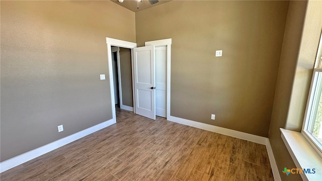 empty room with hardwood / wood-style floors and ceiling fan