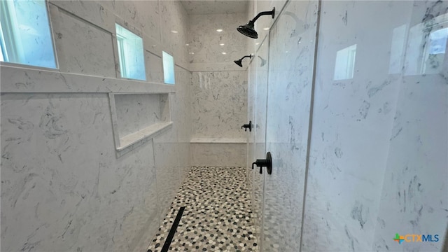 bathroom with a tile shower