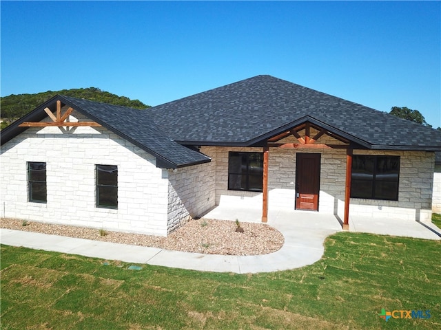 view of front of house featuring a front yard and a patio