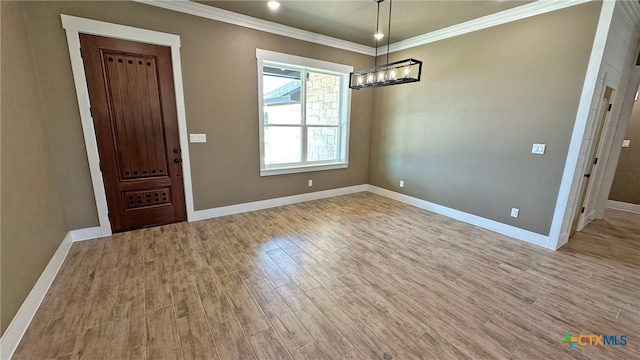 unfurnished dining area featuring light hardwood / wood-style floors, a notable chandelier, and ornamental molding