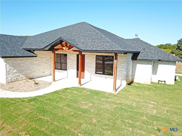 back of house featuring a lawn and a patio