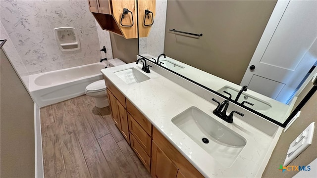 full bathroom featuring hardwood / wood-style floors, washtub / shower combination, toilet, and vanity