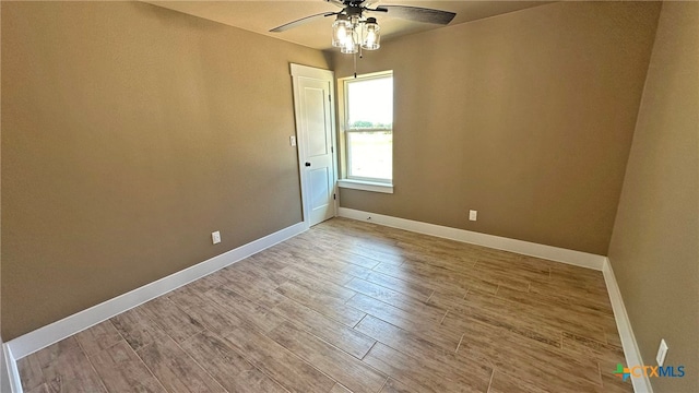 spare room featuring wood-type flooring and ceiling fan