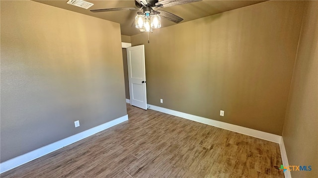 spare room featuring wood-type flooring and ceiling fan