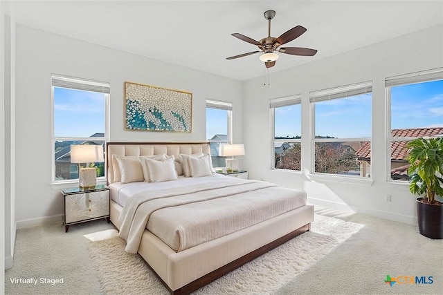 bedroom featuring light colored carpet and ceiling fan