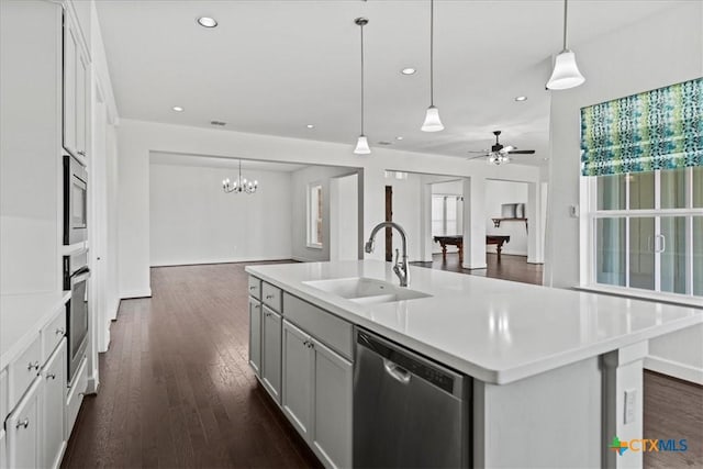 kitchen with sink, hanging light fixtures, a center island with sink, dark hardwood / wood-style flooring, and stainless steel appliances