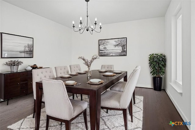 dining space with a notable chandelier and dark wood-type flooring