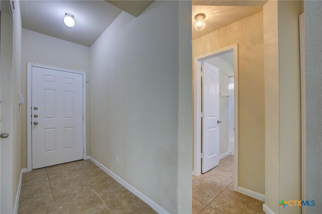 775 Spectrum Dr, New Braunfels, TX 78130 - hallway featuring light tile patterned floors