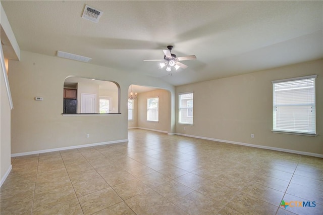 775 Spectrum Dr, New Braunfels, TX 78130 - unfurnished room featuring ceiling fan, light tile patterned floors, a chandelier, and arched walkways