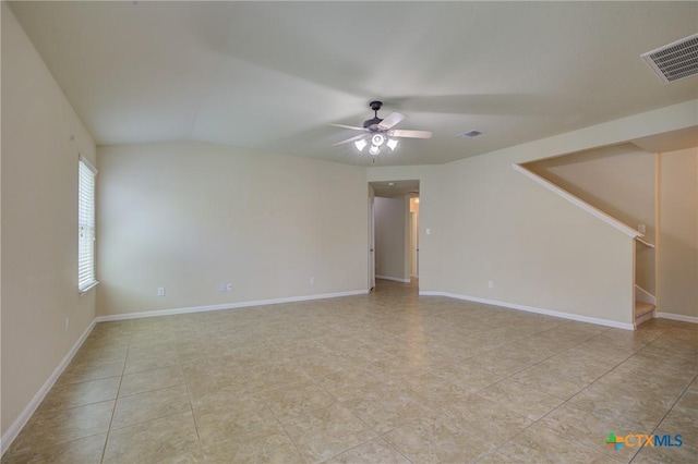 775 Spectrum Dr, New Braunfels, TX 78130 - unfurnished room featuring ceiling fan, stairway, light tile patterned floors, and vaulted ceiling