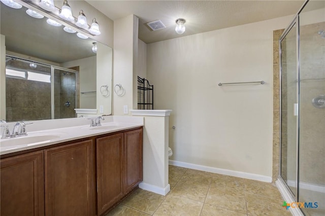 775 Spectrum Dr, New Braunfels, TX 78130 - bathroom featuring a stall shower, tile patterned floors, and double vanity