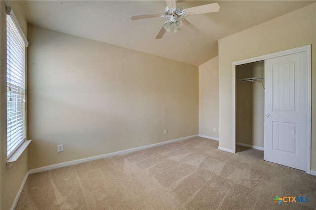 775 Spectrum Dr, New Braunfels, TX 78130 - unfurnished bedroom with light carpet, vaulted ceiling, multiple windows, and a closet