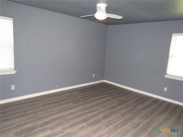 spare room with ceiling fan and dark hardwood / wood-style flooring