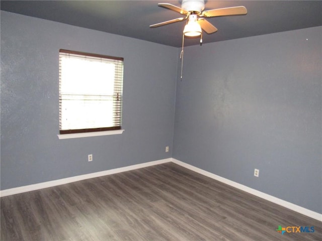 spare room featuring dark hardwood / wood-style floors and ceiling fan