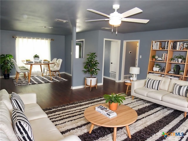 living room with ceiling fan and dark hardwood / wood-style floors