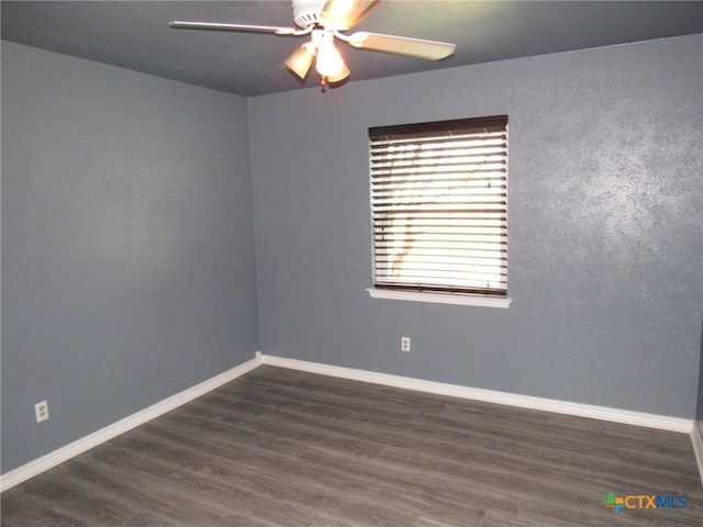 unfurnished room with ceiling fan and dark hardwood / wood-style flooring