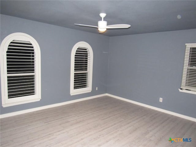 unfurnished room with ceiling fan and light wood-type flooring