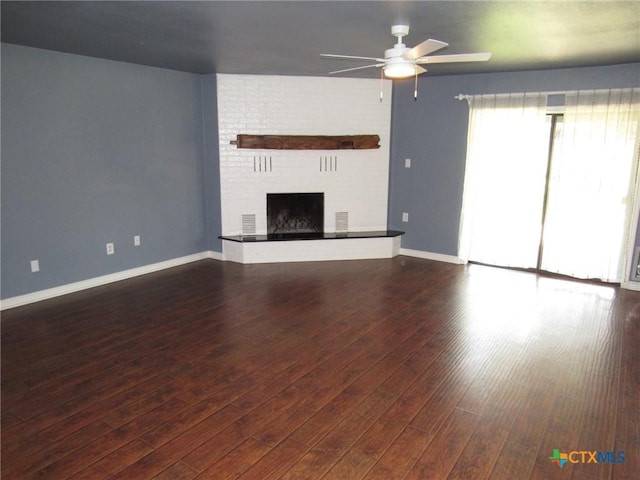 unfurnished living room featuring ceiling fan, a fireplace, and dark hardwood / wood-style flooring