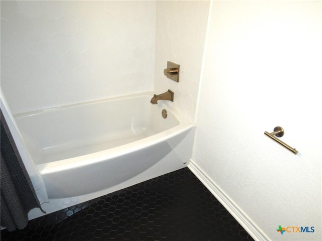 bathroom featuring tile patterned floors and a tub