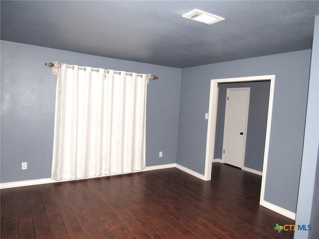 unfurnished room featuring dark hardwood / wood-style floors