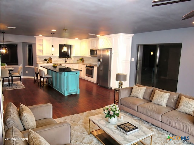 living room with dark wood-type flooring and sink