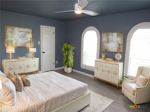 bedroom with hardwood / wood-style floors and ceiling fan