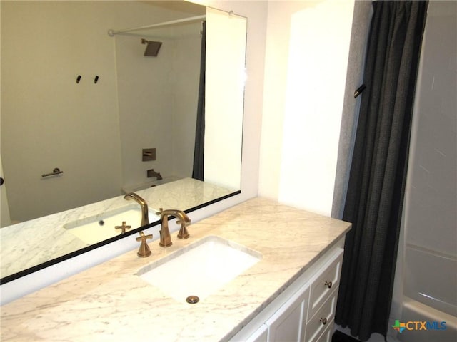 bathroom with shower / tub combo and vanity