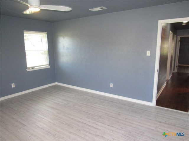 empty room with ceiling fan and light wood-type flooring