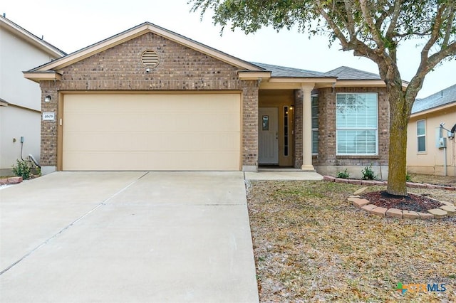 ranch-style home featuring an attached garage, concrete driveway, and brick siding