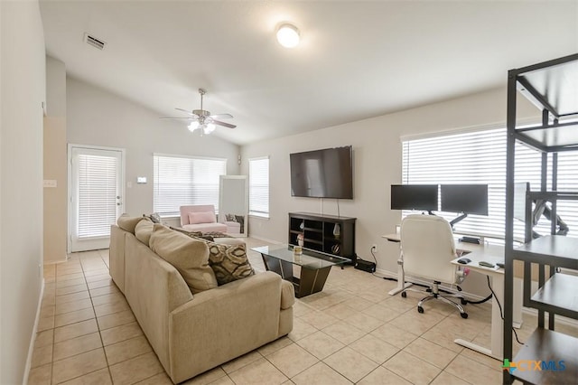 living room with lofted ceiling, visible vents, a ceiling fan, light tile patterned flooring, and baseboards