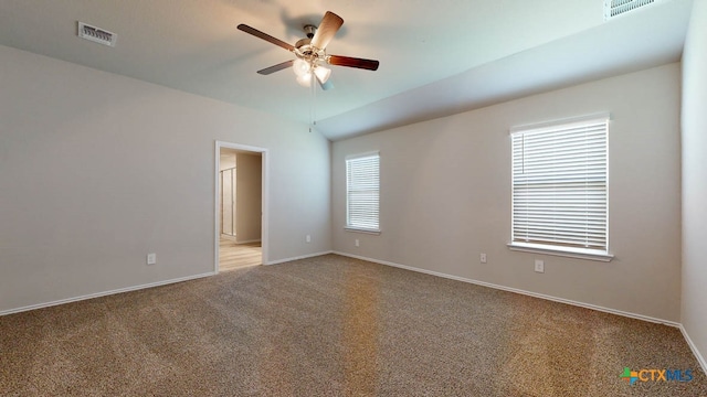 carpeted empty room with a wealth of natural light and ceiling fan