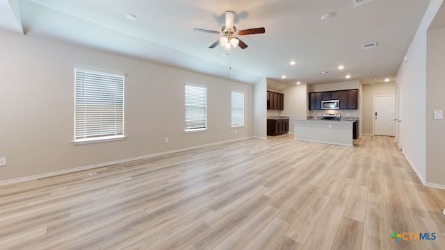 unfurnished living room with light hardwood / wood-style flooring and ceiling fan