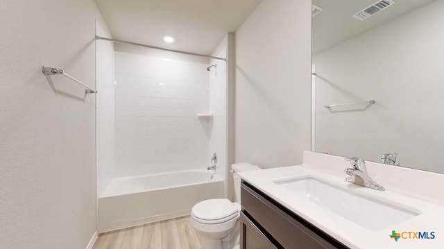 full bathroom with vanity, wood-type flooring, shower / bathtub combination, and toilet