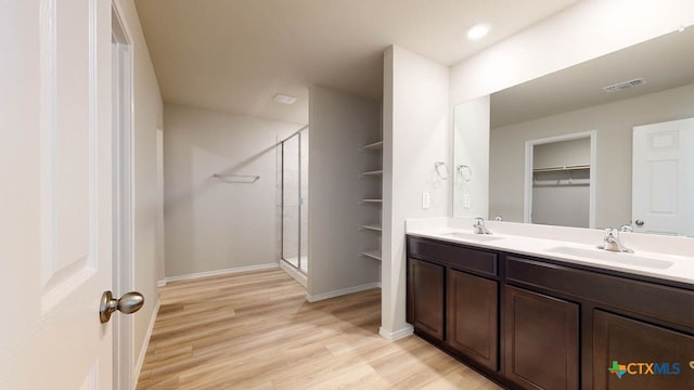 bathroom with vanity, wood-type flooring, and an enclosed shower