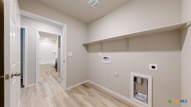 clothes washing area with hookup for a washing machine, light wood-type flooring, hookup for a gas dryer, and electric dryer hookup