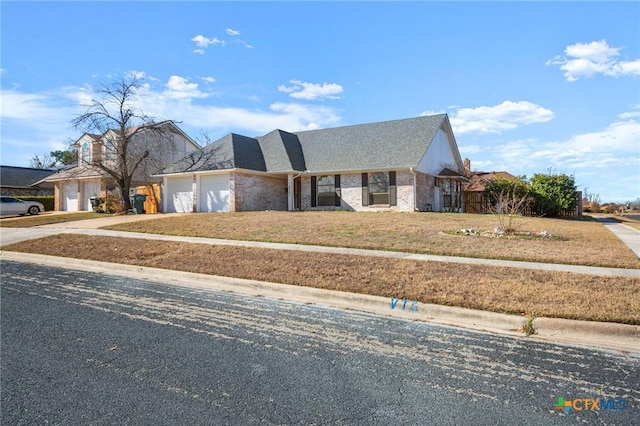 view of front of home with a front yard and a garage