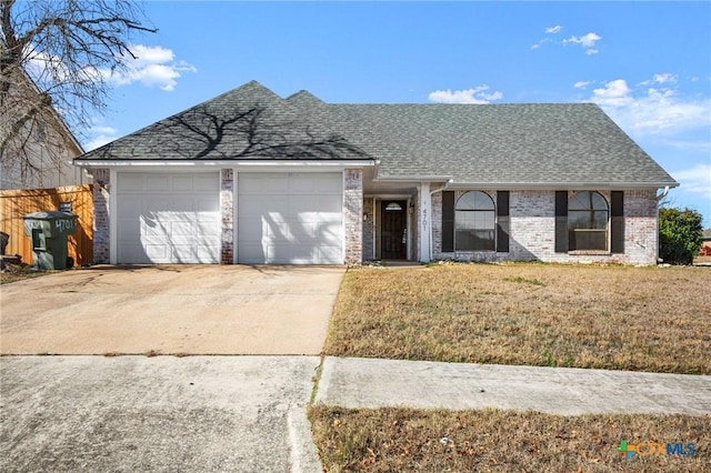 ranch-style home with a front lawn and a garage