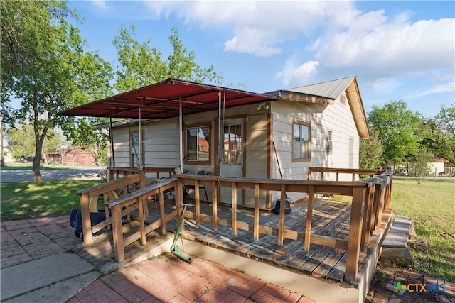 wooden deck featuring a yard