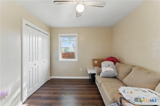 living area featuring a ceiling fan, dark wood-style floors, and baseboards