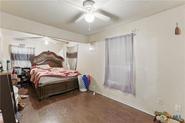 bedroom with baseboards, wood finished floors, and ceiling fan
