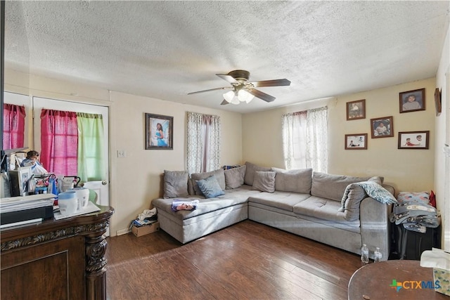 living area with a textured ceiling, a ceiling fan, and wood finished floors