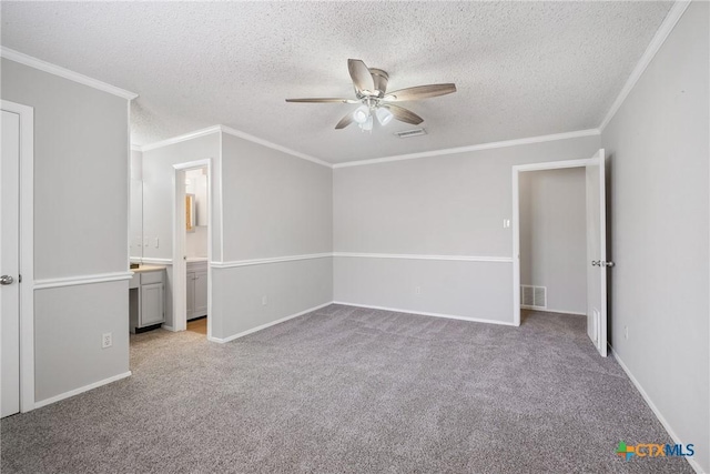 7503 Islander Dr, Austin, TX 78749 - unfurnished bedroom featuring carpet flooring, a textured ceiling, crown molding, baseboards, and ceiling fan