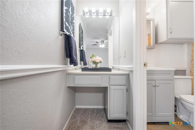 7503 Islander Dr, Austin, TX 78749 - bathroom featuring toilet, a textured wall, vanity, and ceiling fan