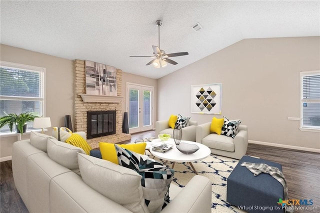 7503 Islander Dr, Austin, TX 78749 - living room with wood finished floors, vaulted ceiling, ceiling fan, baseboards, and a fireplace