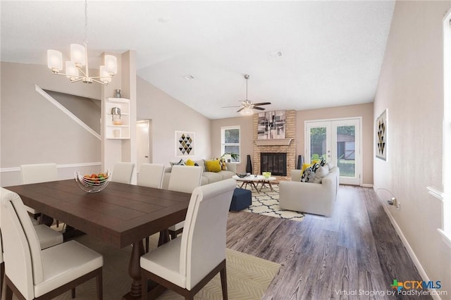 7503 Islander Dr, Austin, TX 78749 - dining space with wood finished floors, ceiling fan, a chandelier, a fireplace, and lofted ceiling