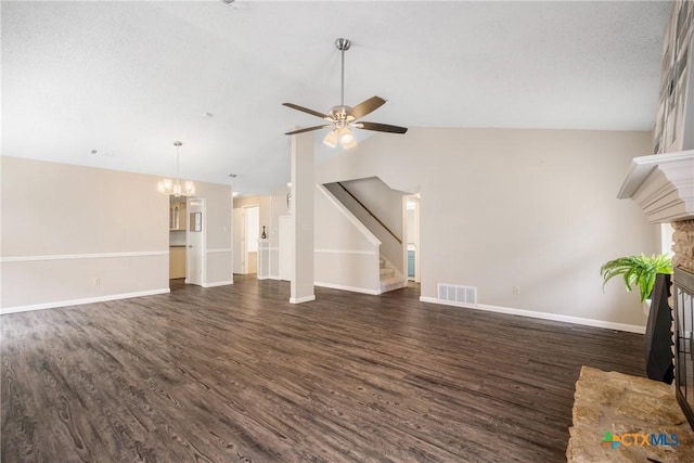 7503 Islander Dr, Austin, TX 78749 - unfurnished living room with a fireplace with raised hearth, dark wood-style floors, vaulted ceiling, stairs, and baseboards