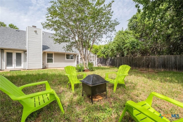 7503 Islander Dr, Austin, TX 78749 - fenced backyard featuring an outdoor fire pit